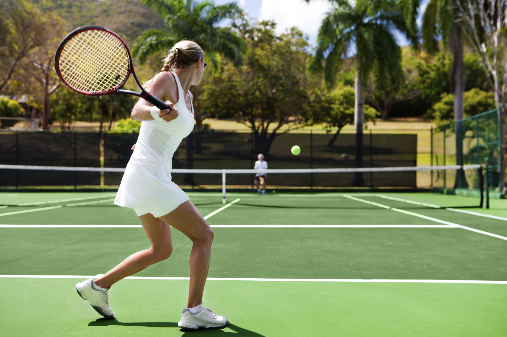 people playing tennis in tropics