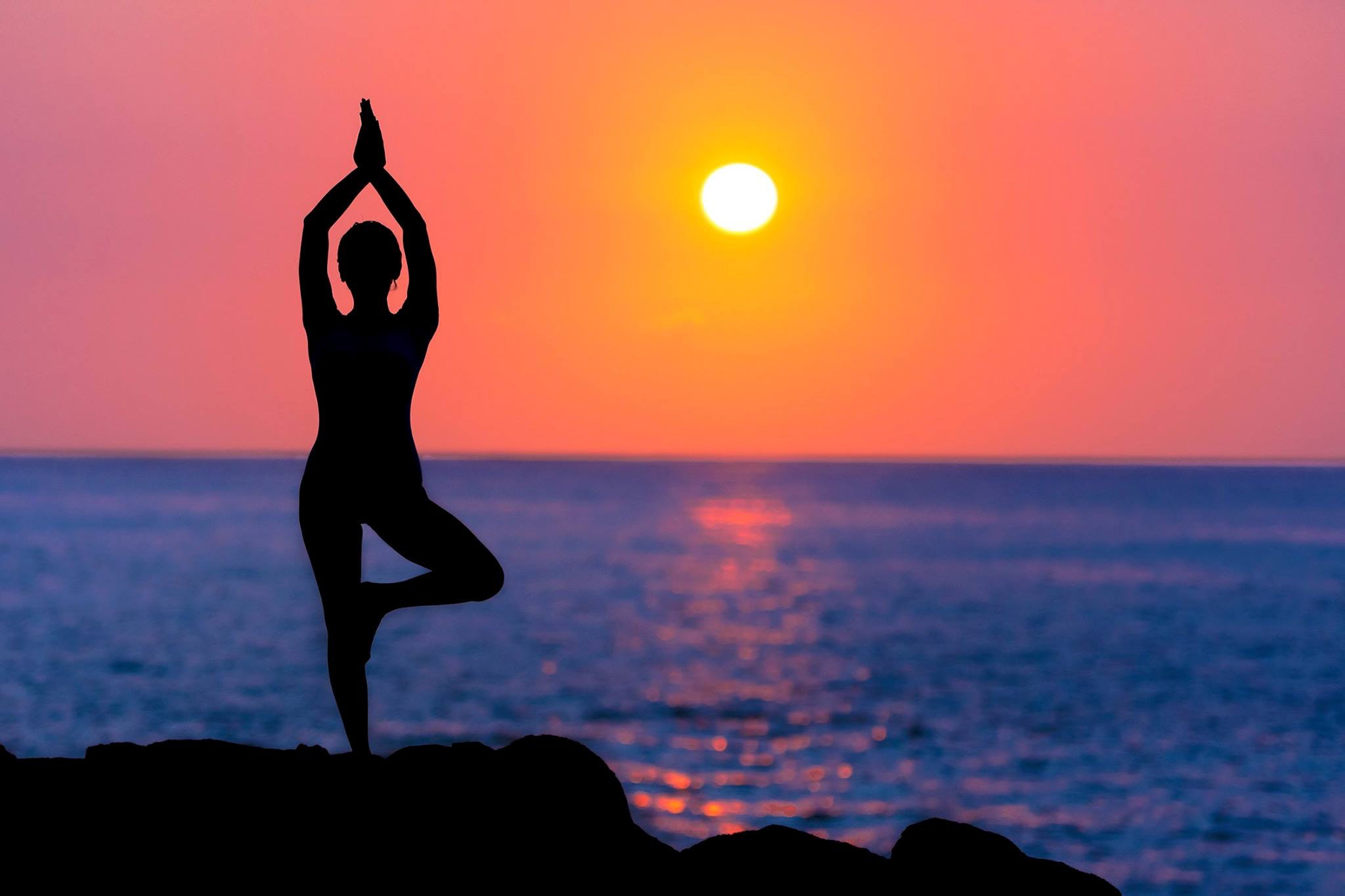 yoga on the beach at sunset